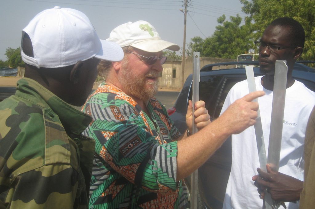CREATE! Founder and Executive Director, Barry Wheeler, talks with the CREATE! Field Team about material preparation for installing the solar pumping system.