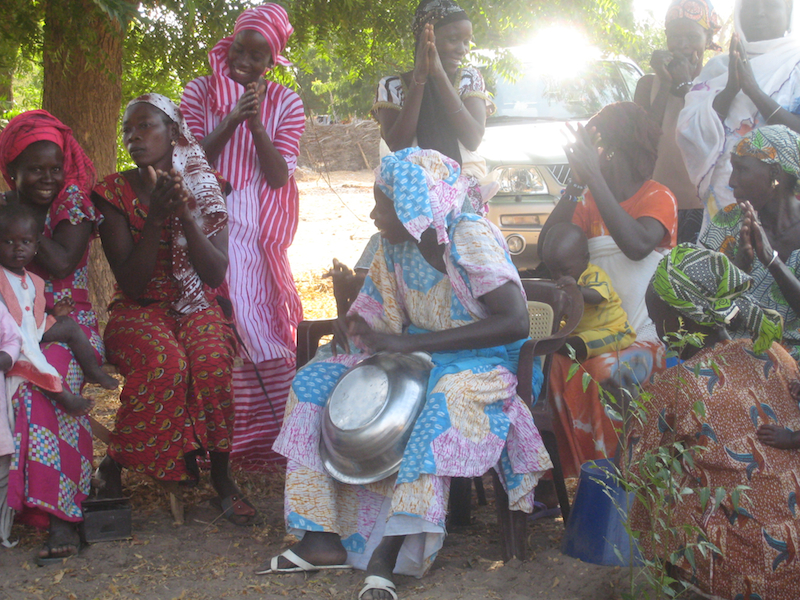 In CREATE!’s new partner community of Walo, women joyously anticipate their new economic and educational opportunities available from CREATE! staff members.