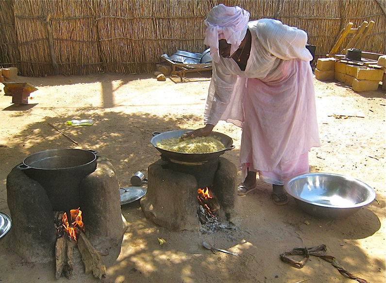 Cooking a whole meal using two cookstoves for Easter in Senega