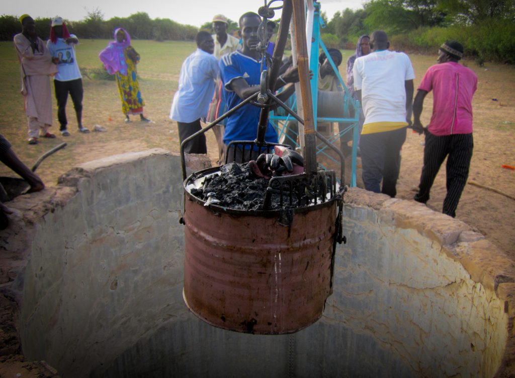 Well rehabilitation: Trash is pulled up from the bottom of the well Well rehabilitation: Trash is pulled up from the bottom of the well