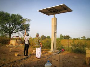 Barry inspects the village of Mboss' solar panel array Barry inspects the village of Mboss' solar panel array